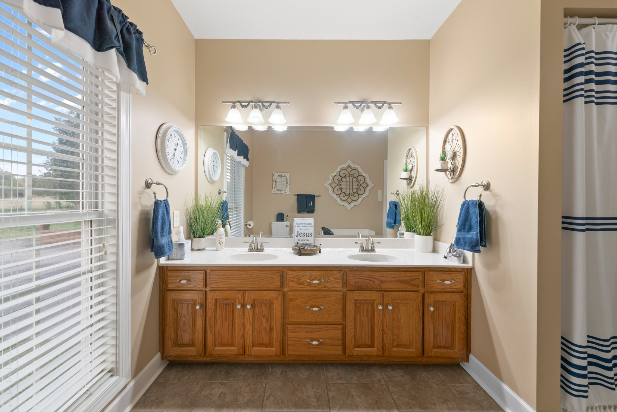 1642 Caughran Road Lewisburg, TN 37091 - Photo 33 of 92 a bathroom with a double vanity sink and a mirror