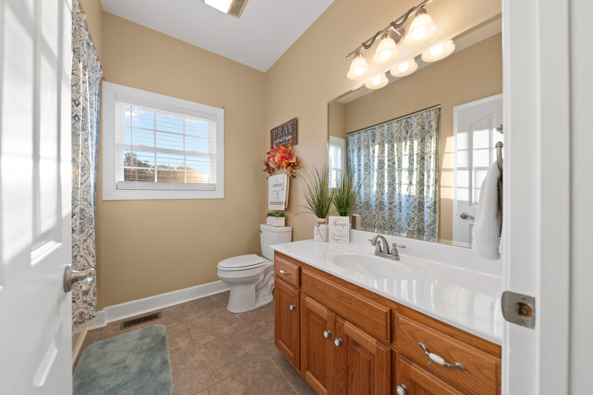 1642 Caughran Road Lewisburg, TN 37091 - Photo 40 of 92 a bathroom with a double vanity sink a toilet and a mirror