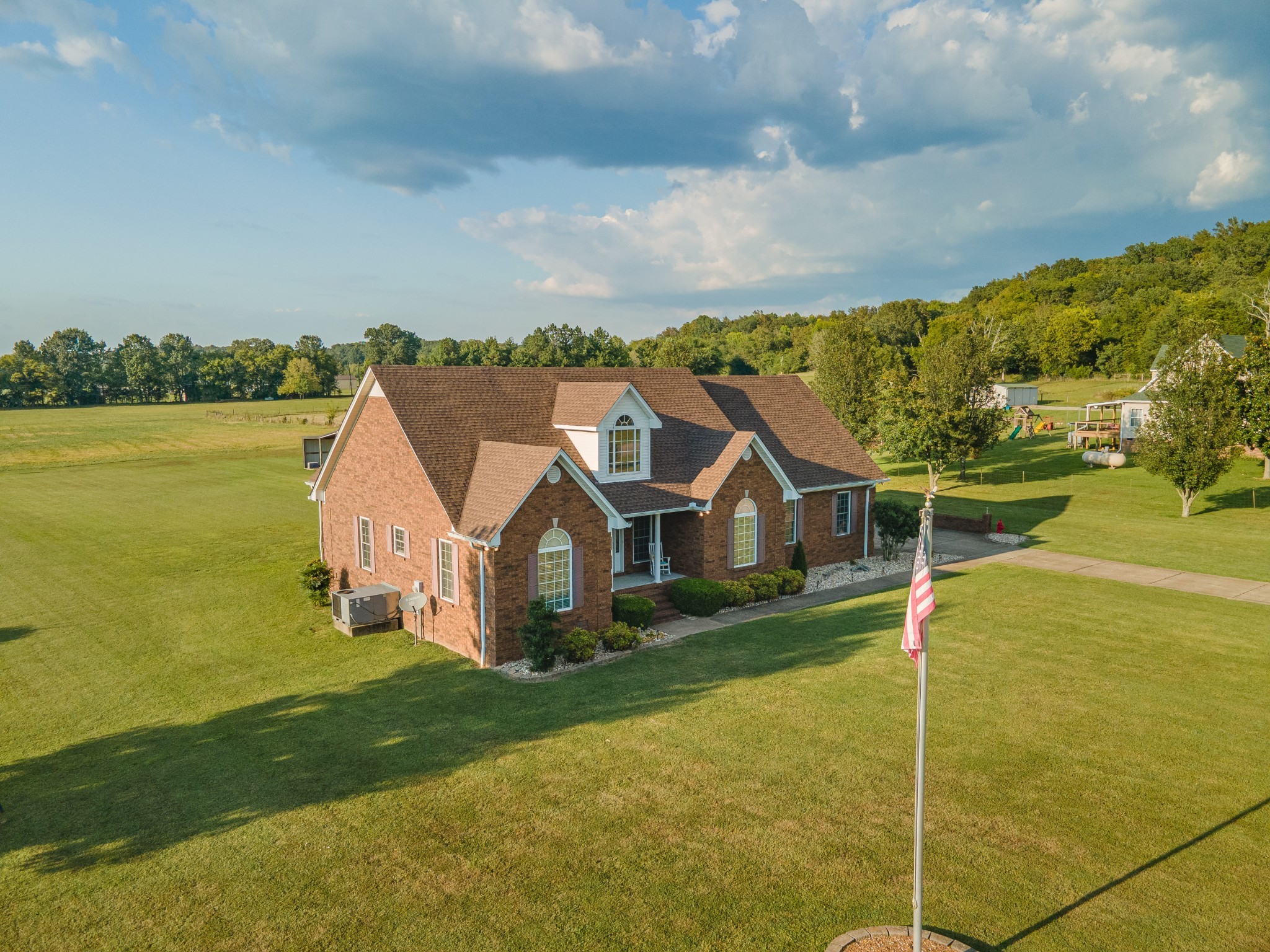 1642 Caughran Road Lewisburg, TN 37091 - Photo 7 of 92 a view of a house with a big yard and potted plants in front of the house