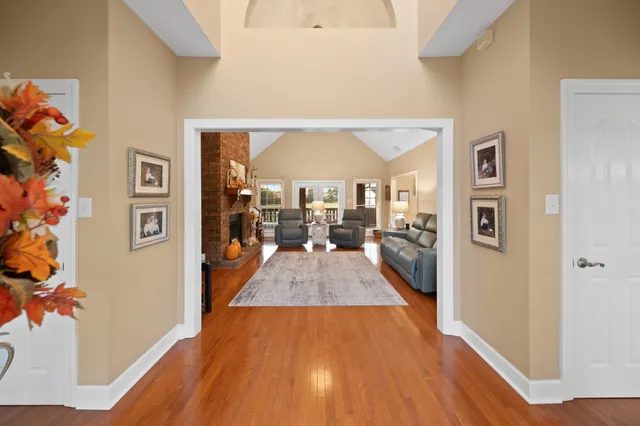 a view of a hallway with wooden floor and staircase