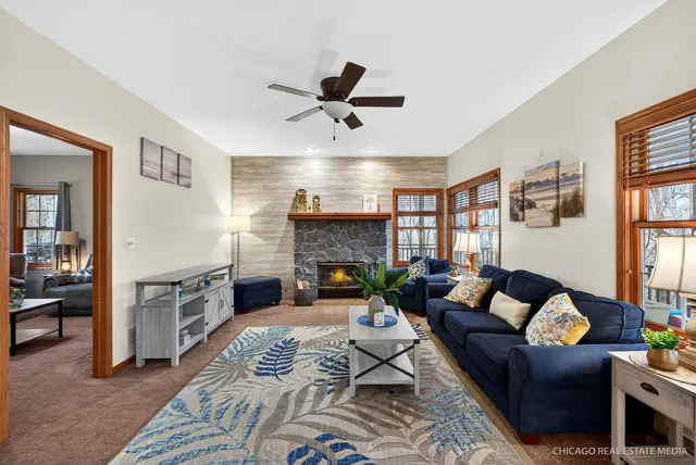a living room with furniture fireplace and a window