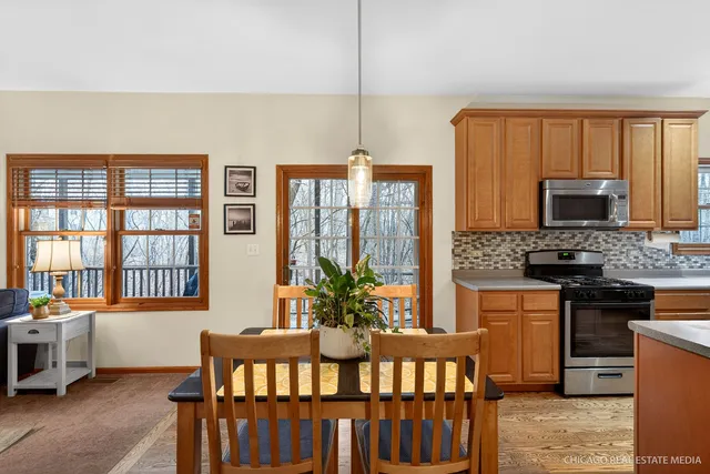 a kitchen that has a stove and a table in it