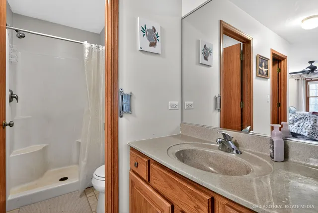 a bathroom with a shower sink and mirror
