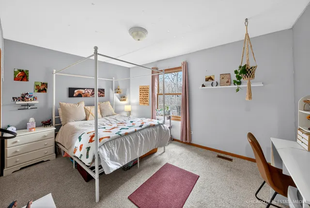 a bedroom with a bed a desk and chair