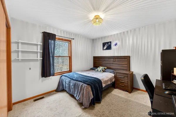 a bedroom with a bed and a table in it