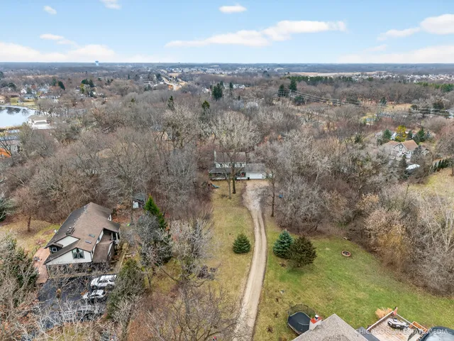 an aerial view of a house with a yard