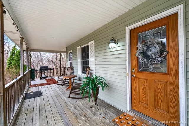 a balcony with furniture and wooden floor