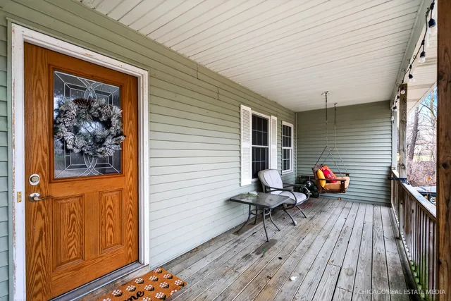 a view of a deck with wooden floors and furniture