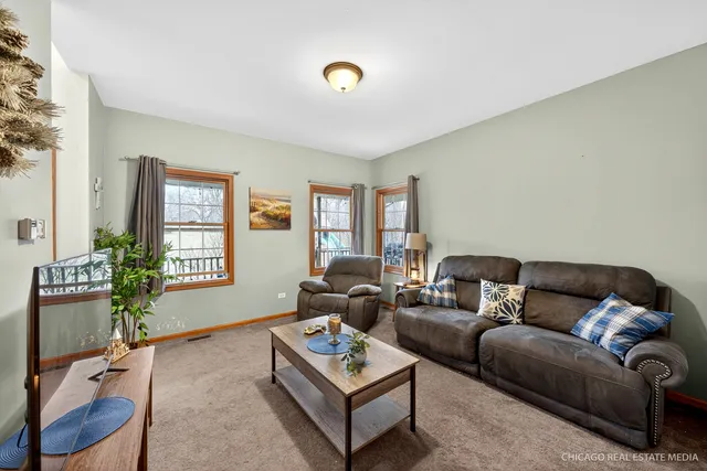a living room with furniture rug and window