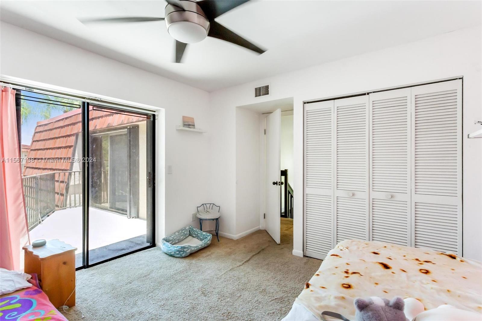 8379 Boca Rio Drive Boca Raton, FL 33433 - Photo 17 of 30 a bedroom with a bed and glass door