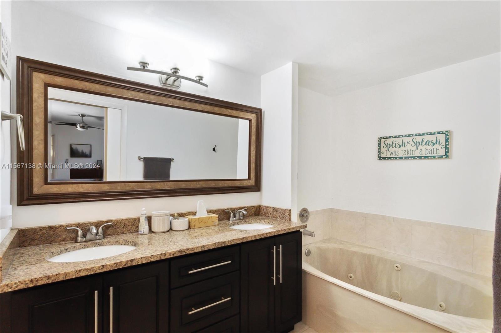 8379 Boca Rio Drive Boca Raton, FL 33433 - Photo 23 of 30 a bathroom with a granite countertop double vanity sink and a mirror