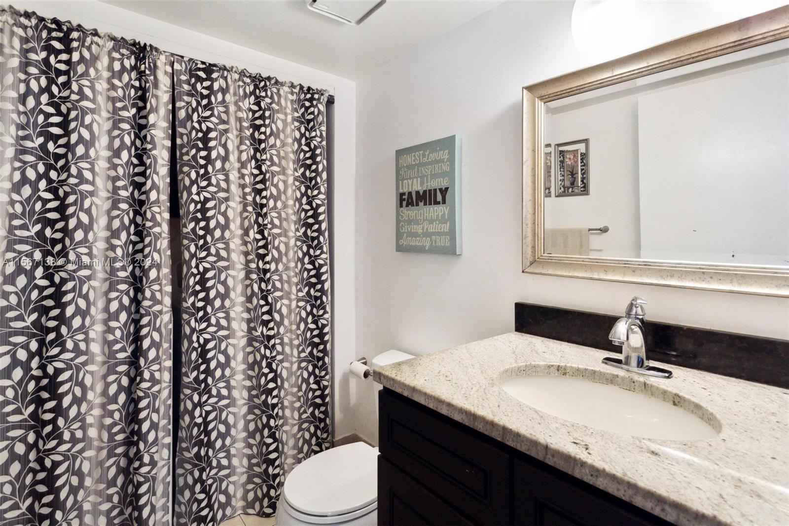 8379 Boca Rio Drive Boca Raton, FL 33433 - Photo 9 of 30 a bathroom with a granite countertop toilet sink and mirror