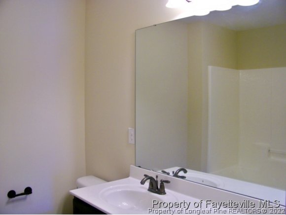114 Sandy Springs Road Aberdeen, NC 28315 - Photo 14 of 18 a bathroom with a sink and a mirror