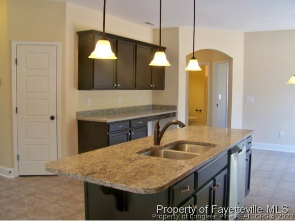114 Sandy Springs Road Aberdeen, NC 28315 - Photo 4 of 18 a bathroom with a granite countertop sink a mirror and shower
