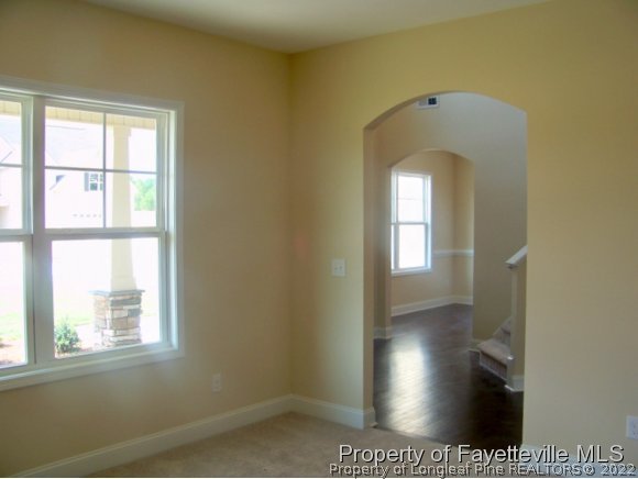114 Sandy Springs Road Aberdeen, NC 28315 - Photo 5 of 18 a view of a hallway with wooden floor and a room