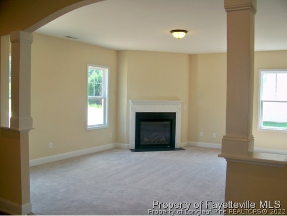 114 Sandy Springs Road Aberdeen, NC 28315 - Photo 7 of 18 a view of an empty room with a window and fireplace