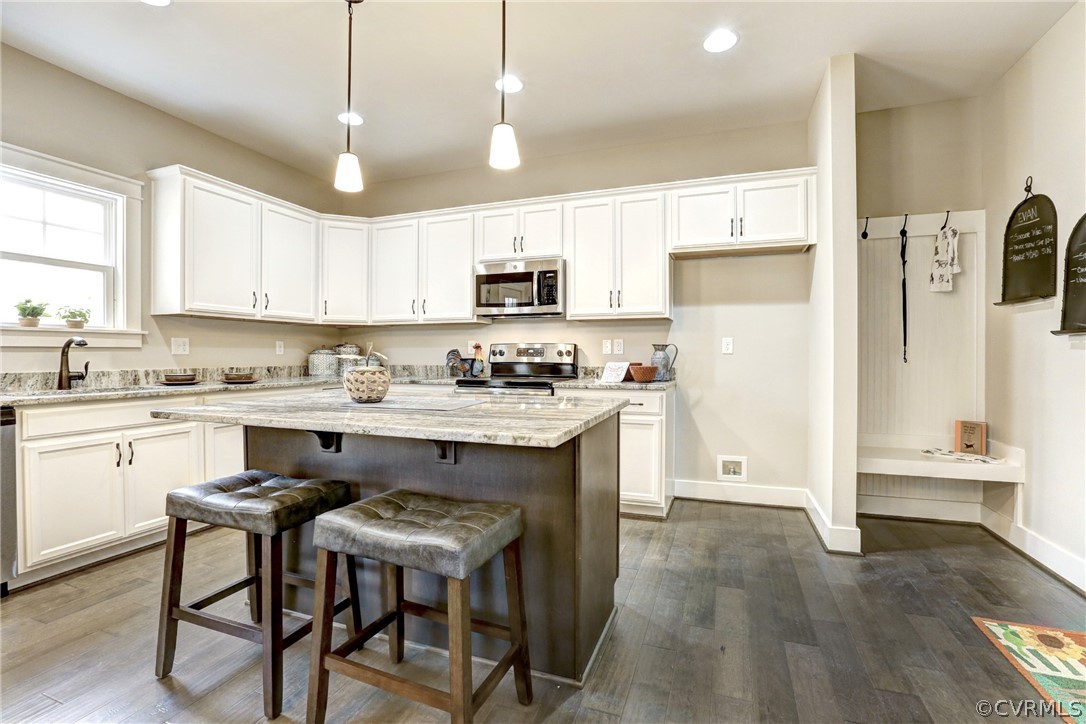 4913 Appelman Ridge Chesterfield, VA 23832 - Photo 10 of 21 a kitchen with stainless steel appliances granite countertop white cabinets a sink a stove a refrigerator and island with wooden floor