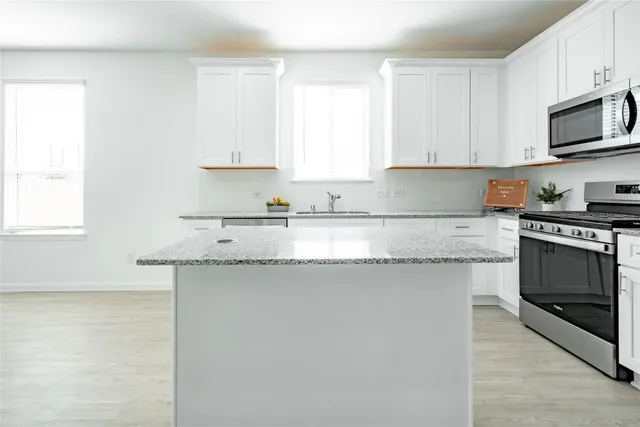 a view of a refrigerator in kitchen and wooden floor