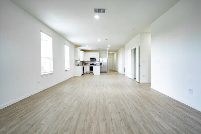 a kitchen with granite countertop a sink stove and microwave