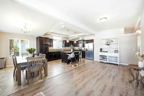 a living room with lots of furniture and kitchen view