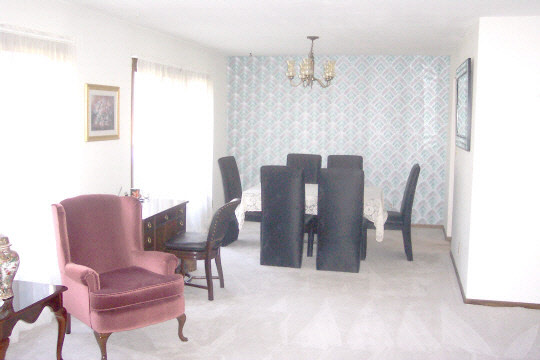 6449 Rendova Court Roscoe, IL 61073 - Photo 3 of 6 a view of a dining room with furniture and a chandelier