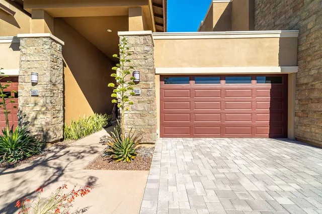 a white toilet sitting next to a white wall
