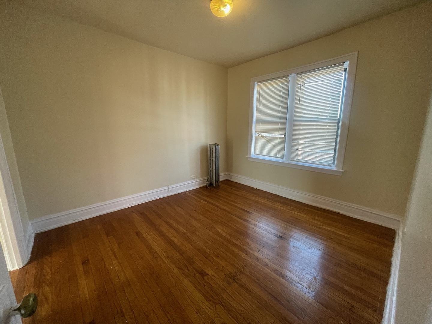 117 East 68th Street, Unit 3 Chicago, IL 60637 - Photo 15 of 17 a view of an empty room with wooden floor and a window