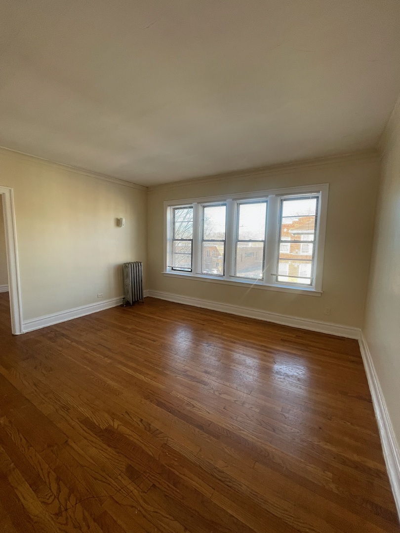 117 East 68th Street, Unit 3 Chicago, IL 60637 - Photo 17 of 17 a view of empty room with wooden floor and fan