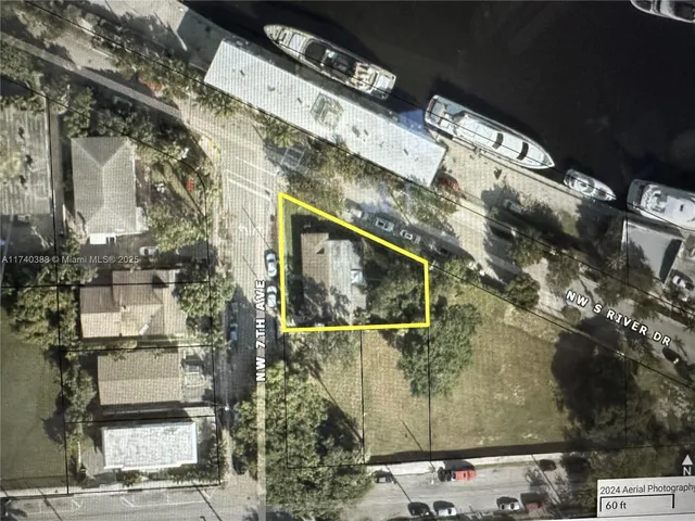 a view of a brick wall with a tree in front of it