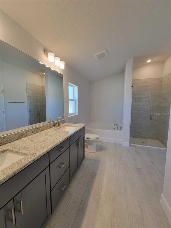 4537 Southwest 91st Ln Road Ocala, FL 34476 - Photo 13 of 18 a spacious bathroom with a granite countertop sink a toilet a shower and a mirror