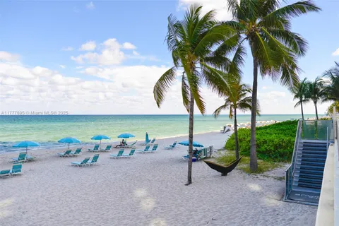 a view of a patio with table and chairs and potted plants