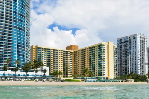 a view of a hallway with livingroom and furniture