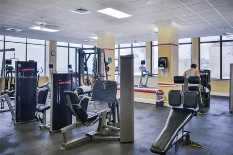 a room with furniture pool table and window