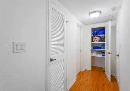 a bedroom with a bed and a view of kitchen