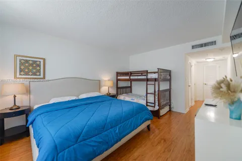 a bedroom with two beds and a book shelf