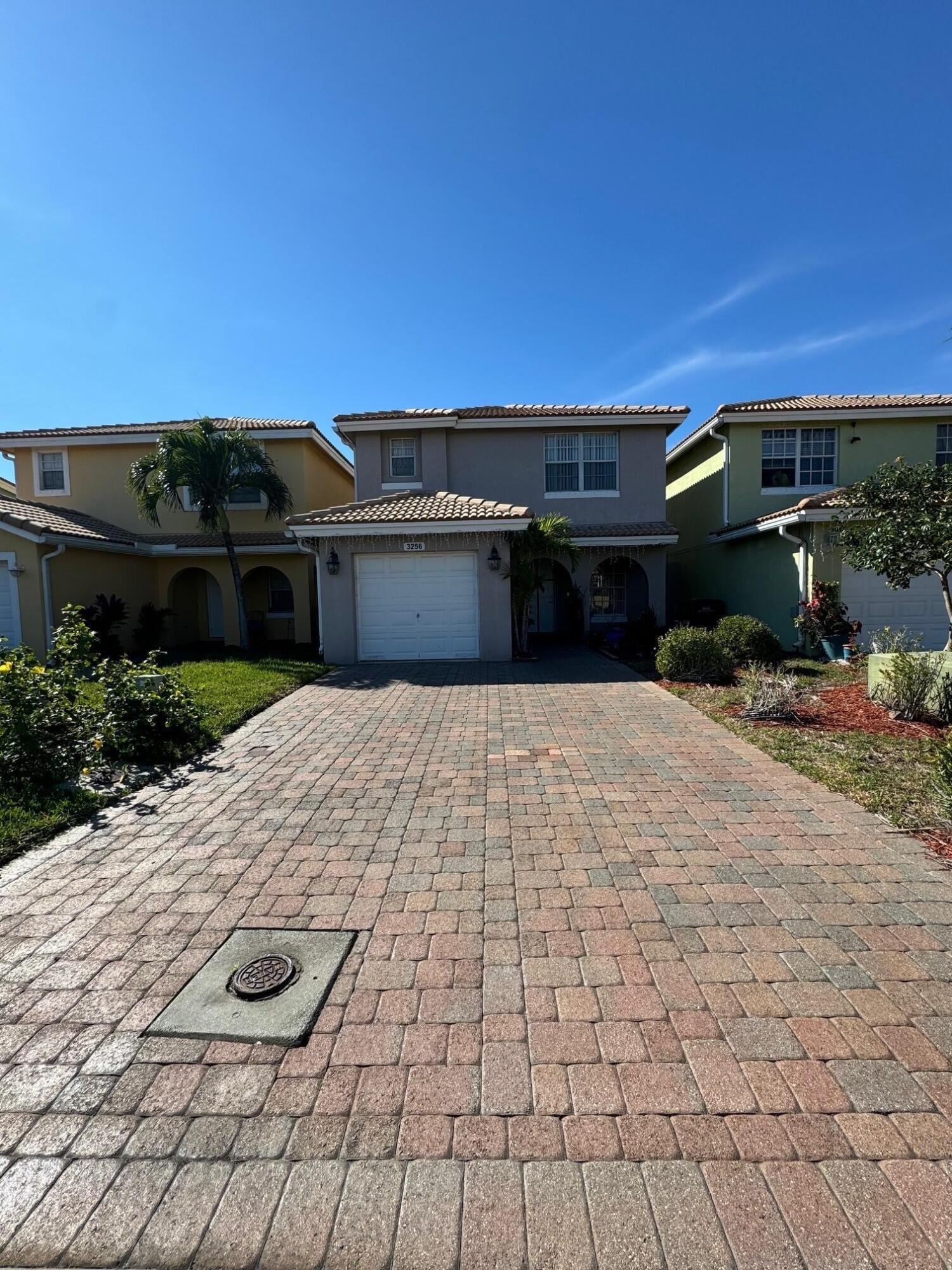 3256 Commodore Court West Palm Beach, FL 33411 - Photo 1 of 7 a front view of a house with a yard