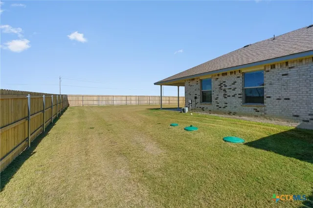 a swimming pool with outdoor seating and yard