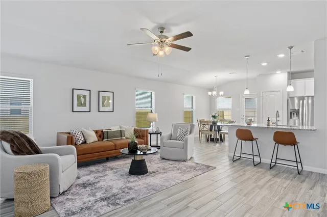 a living room with furniture and a large window