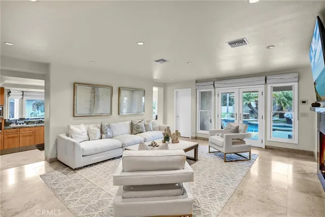 a large white kitchen with stainless steel appliances and cabinets