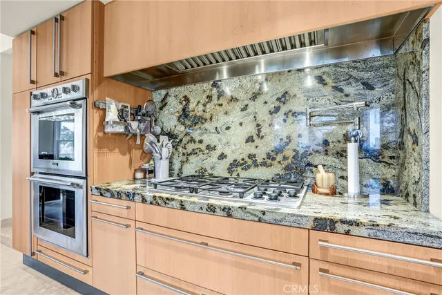 a bathroom with a granite countertop sink mirror and toilet