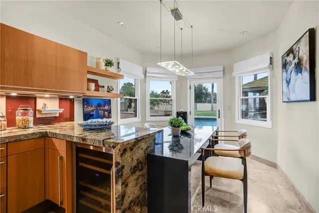 a dining room with furniture and a floor to ceiling window