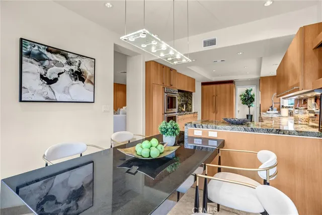 a bedroom with a bed a couch and a flat screen tv