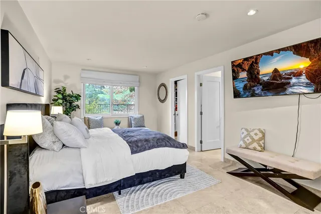 a bedroom with a bed and a couch