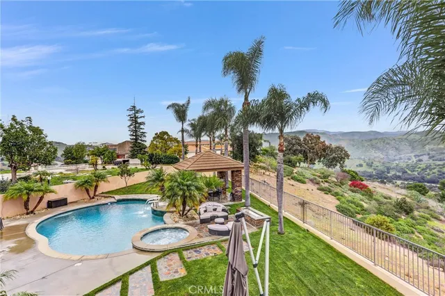 a large brick house with a big yard and large trees