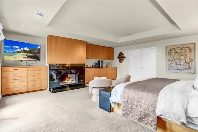 a bedroom with a bed and a dresser in it