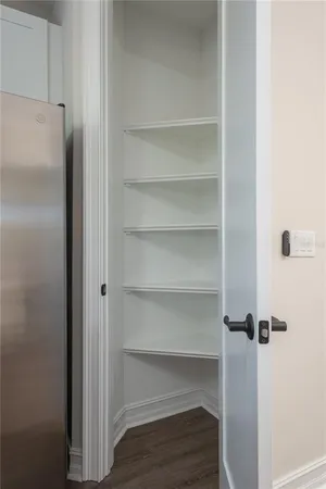 a view of walk in closet with empty racks