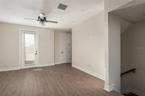 wooden floor in an empty room with a window