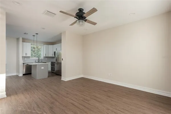 a view of a kitchen with a sink and wooden floor