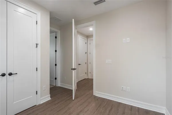 a view of a hallway with wooden floor