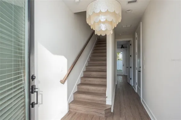 a view of entryway and hall with wooden floor